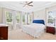 Bedroom featuring a blue upholstered headboard, side tables, and lots of windows for natural light at 7801 Charters End St, Willow Springs, NC 27592