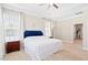 Spacious main bedroom featuring plush carpeting, tray ceiling, two windows, and an ensuite bathroom at 7801 Charters End St, Willow Springs, NC 27592