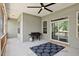 Covered patio with grill, fan, and sliding glass doors, perfect for outdoor dining at 7801 Charters End St, Willow Springs, NC 27592