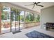 Inviting screened-in patio featuring comfortable seating, a ceiling fan, and a convenient grill at 7801 Charters End St, Willow Springs, NC 27592