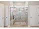 Glass-enclosed shower with tile surround, bench, and a shower head with multiple settings at 7801 Charters End St, Willow Springs, NC 27592