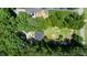 Aerial view of the home, nestled among lush greenery and a manicured yard at 856 Williams White Rd, Zebulon, NC 27597
