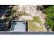 Birds eye view of the wood deck with chairs overlooking the sandy back yard and lush green trees at 856 Williams White Rd, Zebulon, NC 27597