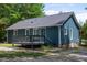 Back exterior view of the home with a private deck and blue vinyl siding at 856 Williams White Rd, Zebulon, NC 27597