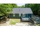 An aerial view of the home's backyard shows the back deck and surrounding wooded landscape at 856 Williams White Rd, Zebulon, NC 27597
