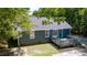 Backyard view of a home featuring a deck, dark roof, and clean siding amongst lush foliage at 856 Williams White Rd, Zebulon, NC 27597