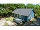 Aerial view of a home's backyard showcasing a deck, blue siding, and green landscaping at 856 Williams White Rd, Zebulon, NC 27597