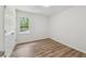A bedroom with wood-look flooring and natural light from a window at 856 Williams White Rd, Zebulon, NC 27597