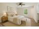 Comfortable bedroom with neutral tones, large window, and warm decor at 856 Williams White Rd, Zebulon, NC 27597