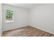 Bedroom with white walls, wood-look flooring and a window to let in natural light at 856 Williams White Rd, Zebulon, NC 27597