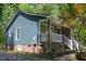 Charming home with stone and vinyl siding, complemented by a cozy front porch and landscaped entrance at 856 Williams White Rd, Zebulon, NC 27597