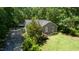 View of the side of the home with stone accents and manicured lawn at 856 Williams White Rd, Zebulon, NC 27597