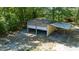 Detached garage featuring a stone facade and a gravel parking pad at 856 Williams White Rd, Zebulon, NC 27597