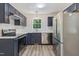 A well-lit kitchen featuring stainless steel appliances, navy cabinets, and wood-look flooring at 856 Williams White Rd, Zebulon, NC 27597