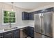 This kitchen offers modern navy cabinets, stainless appliances, and bright white countertops at 856 Williams White Rd, Zebulon, NC 27597