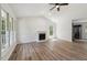 Spacious living room featuring lots of windows, a fireplace and wood-look flooring at 856 Williams White Rd, Zebulon, NC 27597