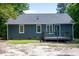 Blue home exterior with a gray back deck, white trim, and lush green yard at 856 Williams White Rd, Zebulon, NC 27597
