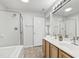 Bathroom featuring double sinks, walk-in shower, and soaking tub at 8610 Neuse Landing Ln # 103, Raleigh, NC 27616