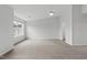Spacious bedroom with neutral carpet, ceiling fan, and bright natural light from the window at 8610 Neuse Landing Ln # 103, Raleigh, NC 27616