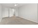 Neutral bedroom with carpet, ceiling fan, and closet, offering ample storage space at 8610 Neuse Landing Ln # 103, Raleigh, NC 27616