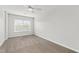 Bright, carpeted bedroom featuring a ceiling fan and window providing natural light at 8610 Neuse Landing Ln # 103, Raleigh, NC 27616