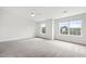 Bright bedroom with carpet, large window, and ceiling fan at 8610 Neuse Landing Ln # 103, Raleigh, NC 27616