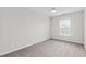 Cozy bedroom featuring carpeted floors, neutral walls, and natural light from window at 8610 Neuse Landing Ln # 103, Raleigh, NC 27616