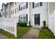 Well-manicured front lawn and a black front door create a charming entrance at 8610 Neuse Landing Ln # 103, Raleigh, NC 27616