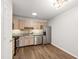 Kitchen featuring stainless steel appliances, wooden cabinets and hardwood flooring at 8610 Neuse Landing Ln # 103, Raleigh, NC 27616