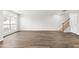Hardwood floors lead to a staircase in a bright and airy living room at 8610 Neuse Landing Ln # 103, Raleigh, NC 27616