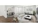 Bright living room with hardwood floors, large windows, and stylish furnishings at 8610 Neuse Landing Ln # 103, Raleigh, NC 27616