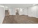 Open-concept living room featuring hardwood floors and staircase to upper level at 8610 Neuse Landing Ln # 103, Raleigh, NC 27616
