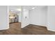 Open-concept living room and kitchen area featuring hardwood floors and stainless steel appliances at 8610 Neuse Landing Ln # 103, Raleigh, NC 27616