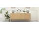 Hallway table with décor, plant, and lamps creating an elegant and welcoming space at 88 Blossom Field Way, Angier, NC 27501
