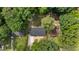 A birds eye view shows the roof, mature trees, and surrounding landscaping at 908 W Garden St, Sanford, NC 27330