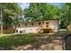 Expansive backyard featuring lush green grass, mature trees, and privacy fence at 908 W Garden St, Sanford, NC 27330