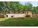 Expansive backyard featuring a patio, lush green grass, mature trees, and privacy fence at 908 W Garden St, Sanford, NC 27330