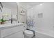 Well-lit bathroom features a shower/tub combo, sleek vanity, and decorative accents at 908 W Garden St, Sanford, NC 27330