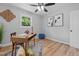 Cozy bedroom featuring wood-look flooring, ceiling fan, and ample natural light at 908 W Garden St, Sanford, NC 27330