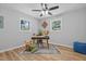Bright bedroom featuring wood-look flooring, ceiling fan, and ample natural light at 908 W Garden St, Sanford, NC 27330
