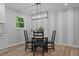 Bright dining area with modern chandelier, table, and seating near a window with natural light at 908 W Garden St, Sanford, NC 27330