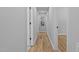 Hallway with wood-look flooring, gray walls, white trim, and decorative art at 908 W Garden St, Sanford, NC 27330