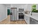 Updated kitchen featuring stainless steel appliances, white cabinetry, and modern countertops at 908 W Garden St, Sanford, NC 27330