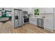 Charming kitchen featuring stainless steel appliances, white cabinets, and a farmhouse sink at 908 W Garden St, Sanford, NC 27330