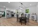 Bright, white kitchen with stainless steel appliances and a dining area with modern lighting at 908 W Garden St, Sanford, NC 27330