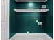 Functional laundry room with modern black and white tile, shelf, and hookups at 908 W Garden St, Sanford, NC 27330