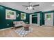 Eclectic living space with bold, dark green walls and hardwood flooring at 908 W Garden St, Sanford, NC 27330