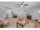 Bright living room featuring stylish furniture, wood floors, and an open layout to kitchen at 908 W Garden St, Sanford, NC 27330