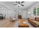 Cozy living room with hardwood floors, modern furniture, and natural light from a large window at 908 W Garden St, Sanford, NC 27330