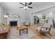 Open-concept living room with a fireplace and seamless flow into a modern, white kitchen at 908 W Garden St, Sanford, NC 27330